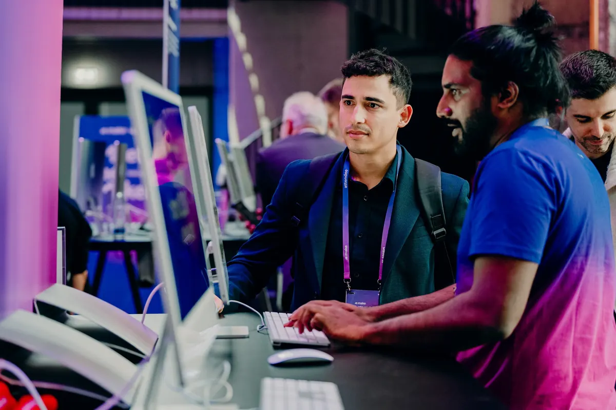 Two attendees working together at a demo station